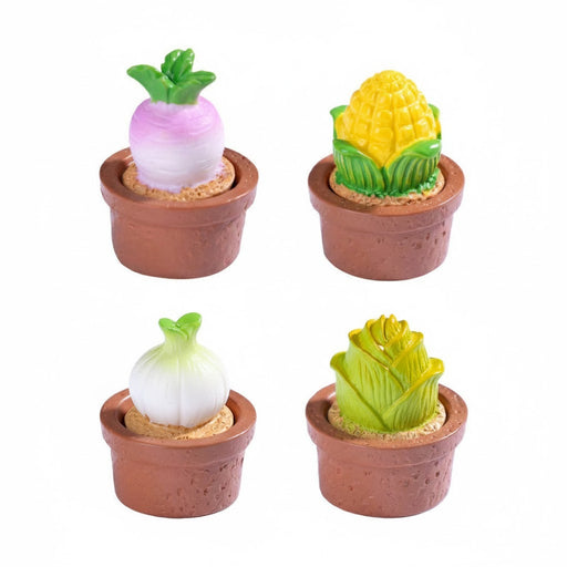 A set of four miniature resin vegetable figurines in small brown terracotta pots, featuring a turnip, an ear of corn, an onion, and a head of lettuce or cabbage.