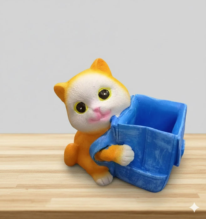 Cute orange and white kitten figurine holding a blue square container.