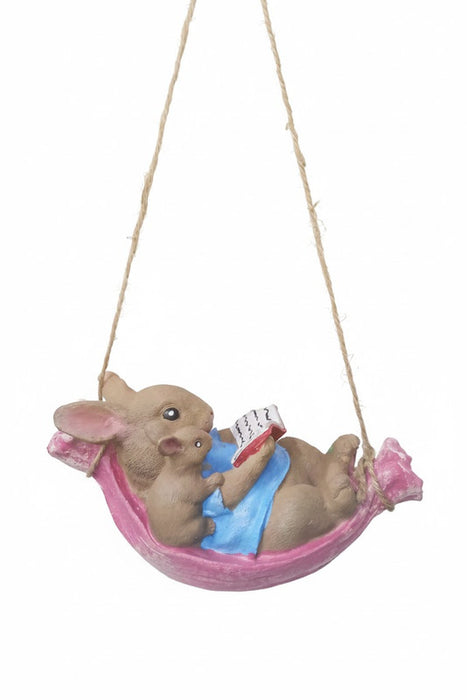 Cute bunny and mouse figurine reading in a pink hanging hammock.