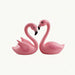 Pink flamingo couple making heart shape with necks, decorative figurine, love symbol.