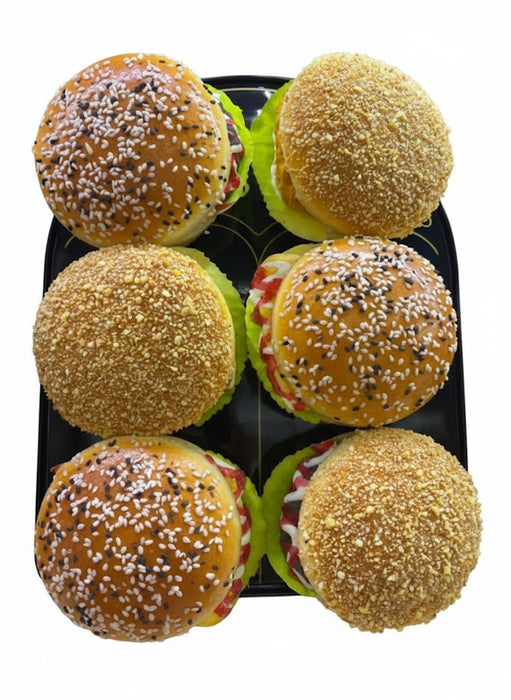 Ultra-realistic artificial cheeseburger model with a sesame seed bun, beef patty, melted cheese, lettuce, and tomato, on a white background.