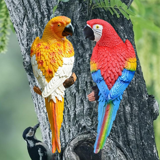 Two colorful resin parrot statues, one red and blue macaw and one yellow and white parrot, perched on a tree branch in a garden.