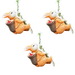 Three hanging resin bunny statues climbing a rope with fruit baskets, whimsical garden tree ornaments, hand-painted orange rabbit figurines for outdoor decor on a white background.