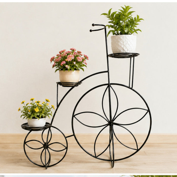 Black metal bicycle plant stand featuring four circular pot holders and vintage wire-wheel designs