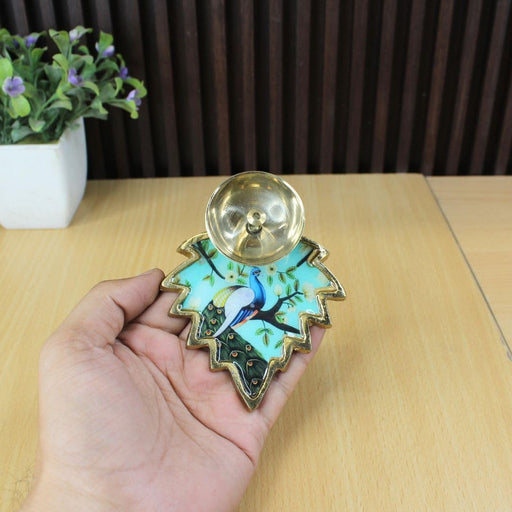 Gold-plated metal leaf-shaped diya with a hand-painted pink lotus flower and green leaf design.