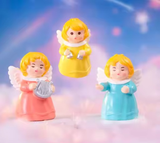 Set of three cute little angel miniatures in pink, yellow, and blue dresses