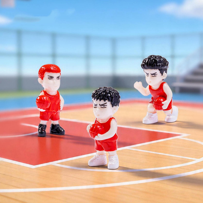 Set of 3 miniature basketball player figurines in red jerseys on a court