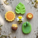 6-piece miniature nature set featuring a cute black and yellow bee, yellow sunflower, brown honey pot with honey drip, green leaf, and textured green figurines