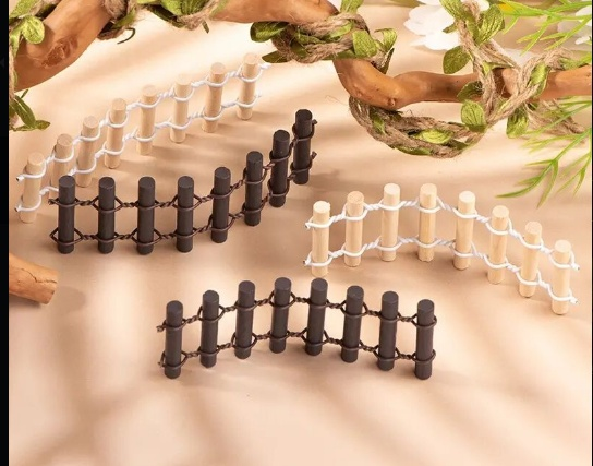 Set of 4 miniature wooden picket fences in light wood and dark brown, bound with wire for fairy garden and terrarium decoration.