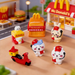 “A 6-piece miniature playset featuring cute cartoon characters in fast-food delivery caps and headsets, a miniature delivery scooter, and a fast-food restaurant kiosk on a tabletop.”