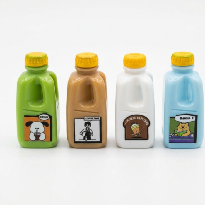 A set of 4 colorful miniature milk and drink bottles in green, brown, white, and blue, featuring yellow caps and cute cartoon sticker labels,