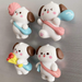 Set of four cute kawaii white and brown puppy miniature figurines with pink cheeks, carrying blue and pink sling bags, holding accessories like flowers and a balloon,