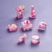 Set of 8 cute pink Hello Kitty miniature musical instruments including a mini piano, guitar, drum, and speakers