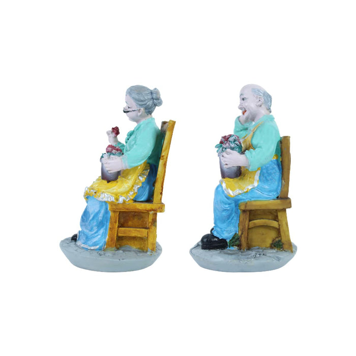 Old Couple Sitting on Chair Statue
